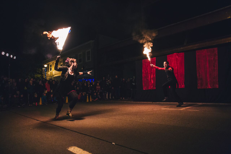 Susan engaging in a fire-sword fight with another performer